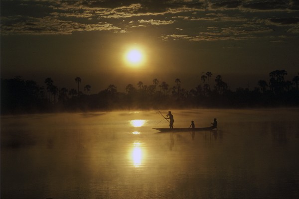 Michael Friedel "The Kuikuru. Sunrise on the Kuluene river lagoon. Shooting torped-rays with a bow a