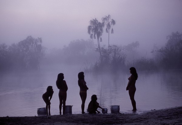Michael Friedel "The Yawalapiti. Pre-dawn mist on the Tuatuari; Fetching water is women's work"